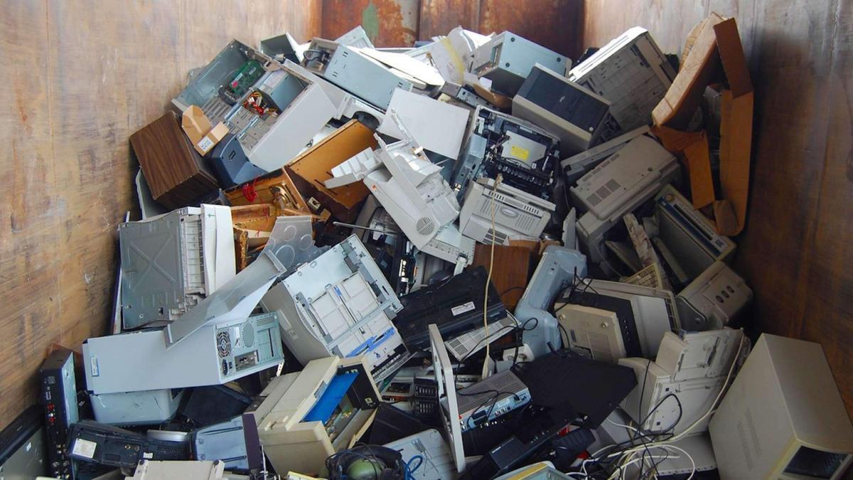 Old Electronics In Metal Dumpster